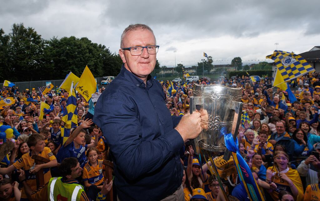 Clare manager Brian Lohan lifts the Liam MacCarthy cup in Ennis on Monday evening. Photograph: Tom Maher/Inpho