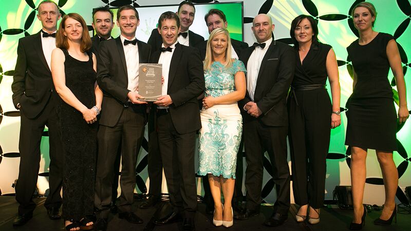 Bernie Kiely, Assistant Principal in the Waste and Resource Efficiency Division, Department of Communications, Climate Action & Environment, presents the Green Business of the Year award to the SSE, Roadbridge & Coillte teams.