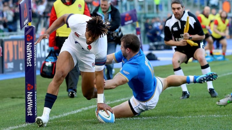 England’s Anthony Watson scores their first try despite the attempted tackle of Italy’s Tommaso Castello during the Six Nations match at Stadio Olimpico. Photograph: Tommy Dickson/Inpho