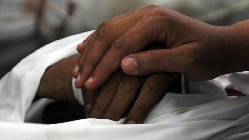 The widow of a dead Muslim Brotherhood supporter touches her husband’s hand at the Al Imam mosque in Cairo. Photograph: Amr Abdallah Dalsh/Reuters
