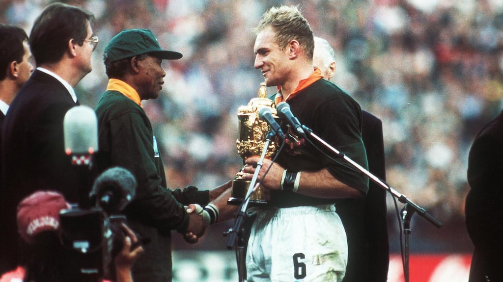 Nelson Mandela hands the Webb Ellis trophy to Francois Pienaar in 1995. Photograph: Billy Stickland/Inpho