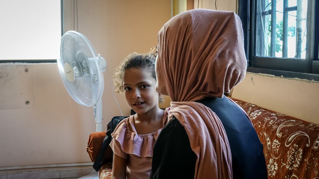 Aisha Al-Qassem (35), with one of her children. Having fled their home as Israeli forces conducted air raids, they live with 10 other family members in Ein el-Hilweh, Lebanon’s largest Palestinian camp. Photograph: Sally Hayden