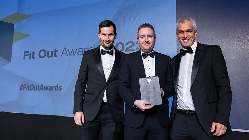 Shaun Bonner, group sales director at Etag Fixings, presents the fit out sub-contractor of the year award to Stephen Goulding and Barry Goulding, BSG Design