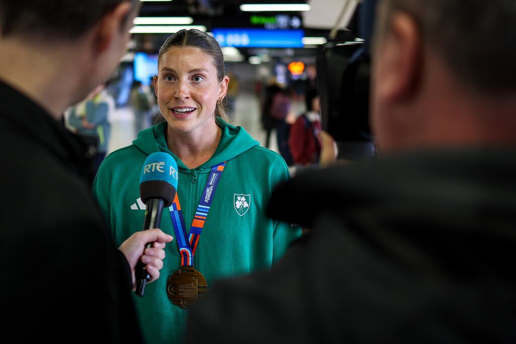 Kate O'Connor speaks to media after arriving back at Dublin airport with her pentathlon medal from the European Indoor Championships. Photograph: Ben Brady/Inpho