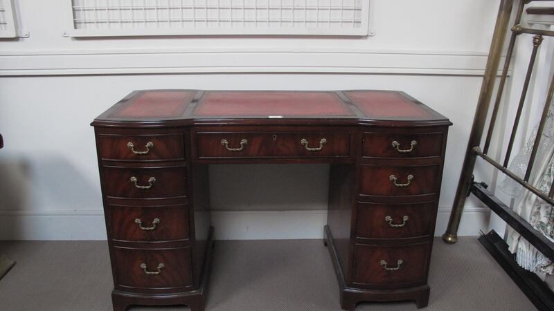 Lot 110, a mahogany pedestal desk with red leather top, which belonged to the late PJ Mara, €200-€400