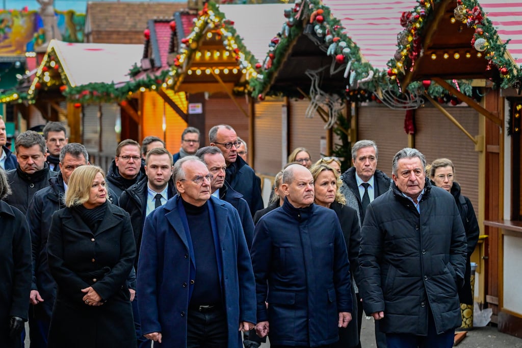 German chancellor Olaf Scholz (second from right) and other politicians visit the site of a car-ramming attack on a Christmas market in Magdeburg, Germany, on Saturday. Photograph: John Macdougall/Getty Images