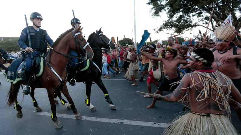Police confront native Brazilians to prevent them from marching towards the Mane Garrincha soccer stadium during a demonstration in Brasilia last night. Photograph: Reuters
