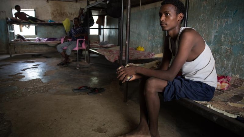 An Eritrean teenager sits on his bed in the unaccompanied minors section of Shagarab refugee camp, eastern Sudan. Photograph: Sally Hayden