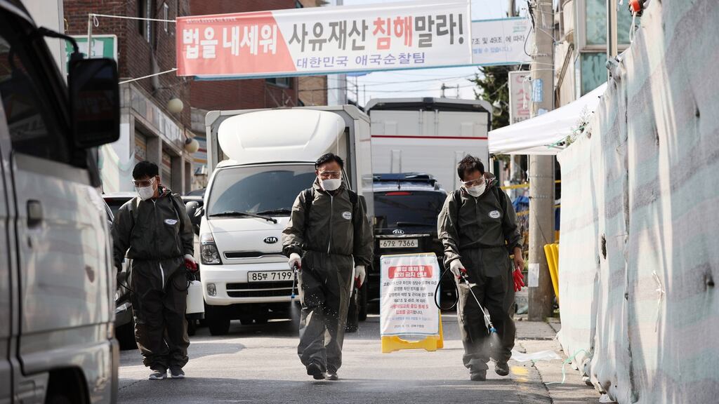 Health officials disinfect streets around Sarang Jeil Church in Seongbuk, Seoul, South Korea. Photograph: Yonhap/EPA