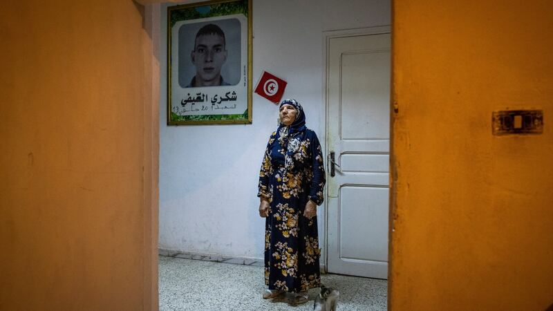 Saida el-Sifi at her home in Tunis with a portrait of her son who was killed in Tunisia’s 2011 revolution. Photograph: Ivor Prickett/New York Times