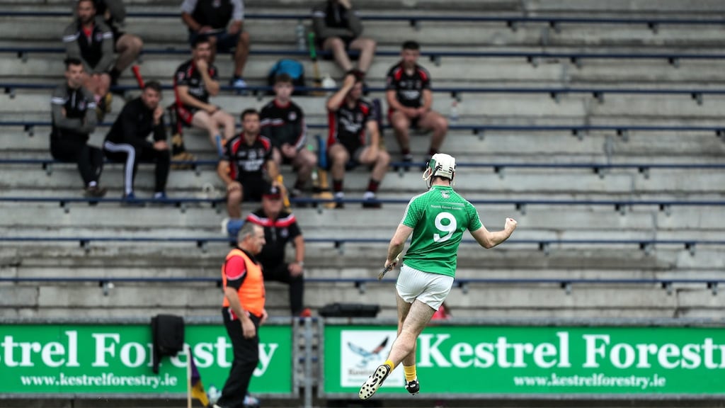 Naomh Éanna’s Gary Molloy celebrate scoring a goal in the Wexford hurling semi-final in front of the Oulart The Ballagh substitutes. Photograph: Laszlo Geczo/Inpho