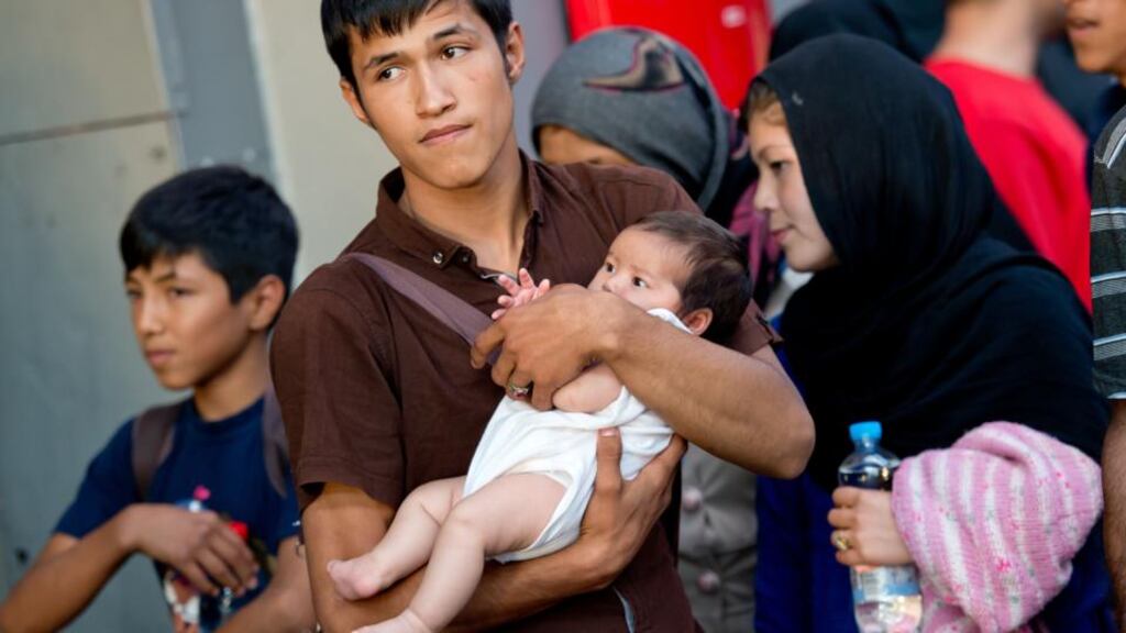A migrant family from Afghanistan after arrival  from Budapest, Hungary,  at the train station in Munich, Germany, August 31st, 2015. Photograph: Sven Hoppe/AFP/Getty Images