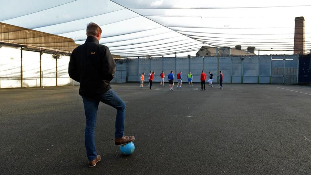 Coach Daniel Lambert looks on as prisoners train on the outdoor pitch at Mountjoy Prison in Dublin. Photo: Eric Luke