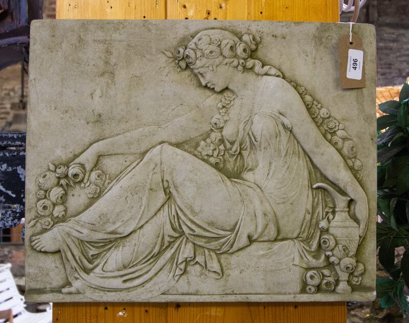 Composite stone plaque, Lady with Roses (€60-€100), at Keighery's garden furniture auction