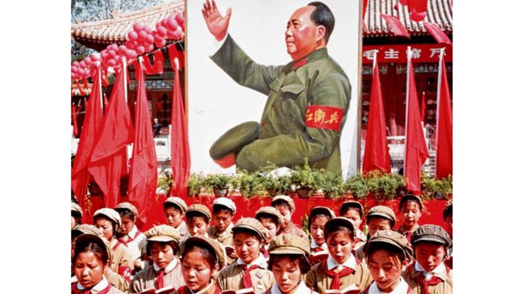 Chinese children read Chairman Mao's Little Red Book in front of an image of Mao in 1968. photograph: hulton/getty