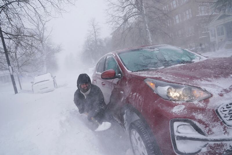 Gamaliel Vega tries to dig out his car after he got stuck in a snowdrift. Photograph: Derek Gee/The Buffalo News/AP