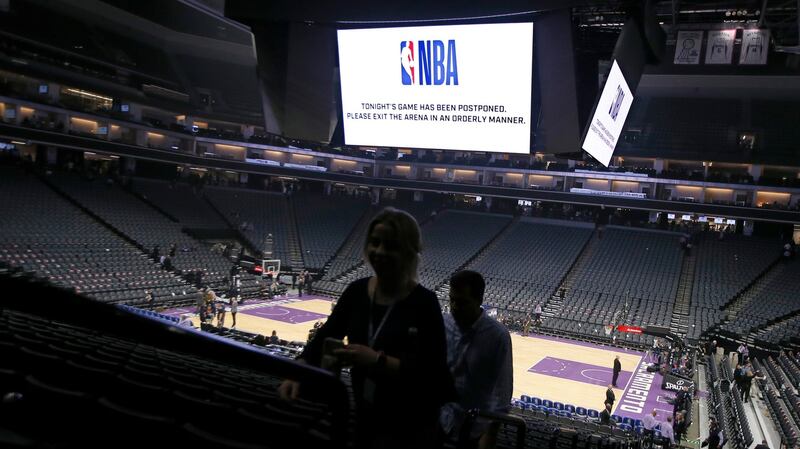Fans leave the Golden 1 Center after the NBA game between the New Orleans Pelicans and Sacramento Kings was postponed in Sacramento, California on Wednesday. Photograph: Rich Pedroncelli/AP Photo
