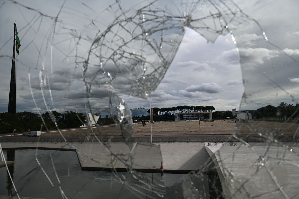 A broken window of Planalto Palace in Brasilia a day after supporters of Brazil's far-right ex-president Jair Bolsonaro invaded the Congress, presidential palace and supreme court. Some claim 'The world has been in a democratic recession for years.' Photograph: Mauro Pimentel/AFP