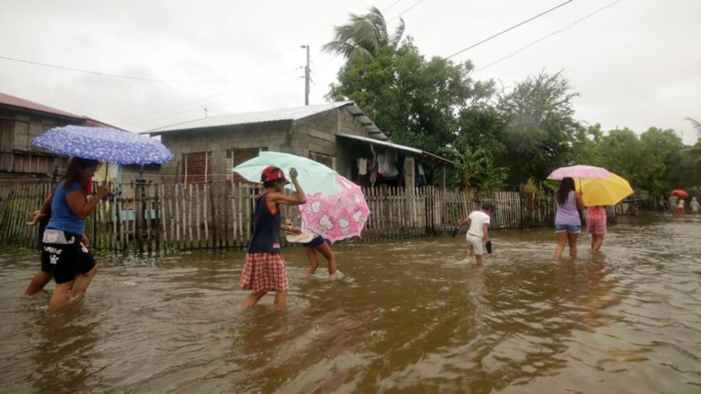 Filipino villagers manoeuvre on floodwater in Laoag city, Ilocos Norte province. Typhoon Goni struck the northern Philippines, killing at least 15 people. Photograph: Bernie Sipin Dela Cruz/EPA
