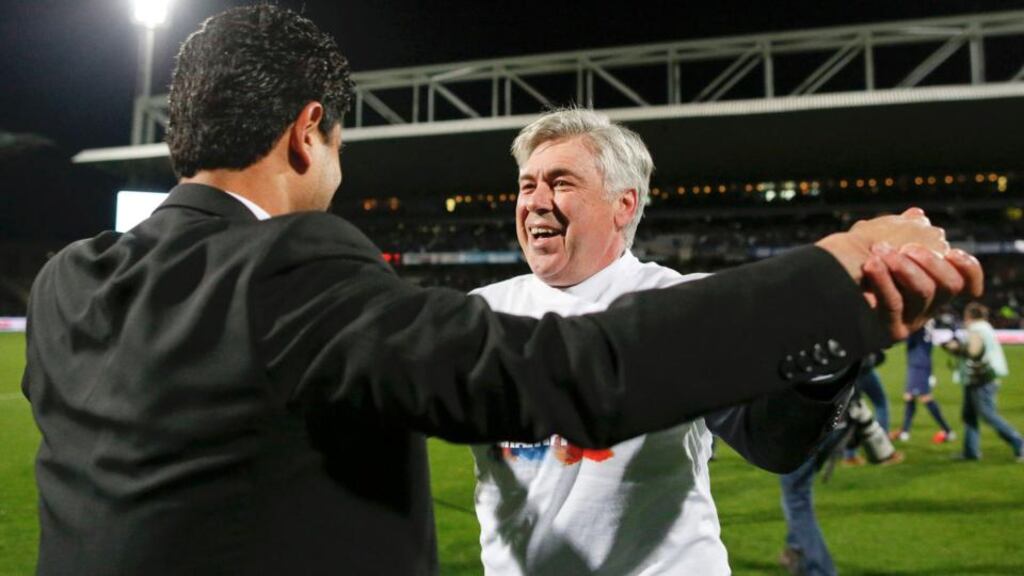 Paris Saint-Germain’s owner Nasser al Khelaifi congratulates coach Carlo Ancelotti after the club secured the Ligue 1 title with a 1-0 victory over Olympique Lyon at the Stade Gerland on Sunday. Photograph: Robert Pratta/Reuters