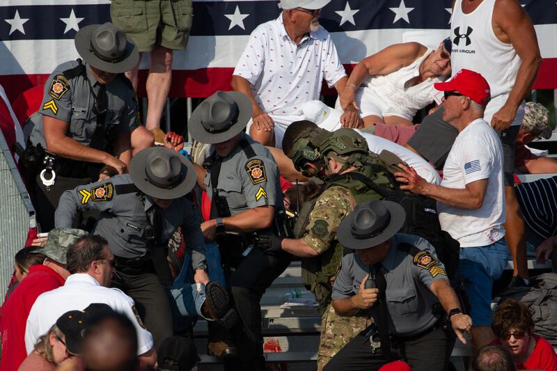 A person is removed by state police from the stands after an attack on Donald Trump. Photograph: REBECCA DROKE/AFP via Getty Images