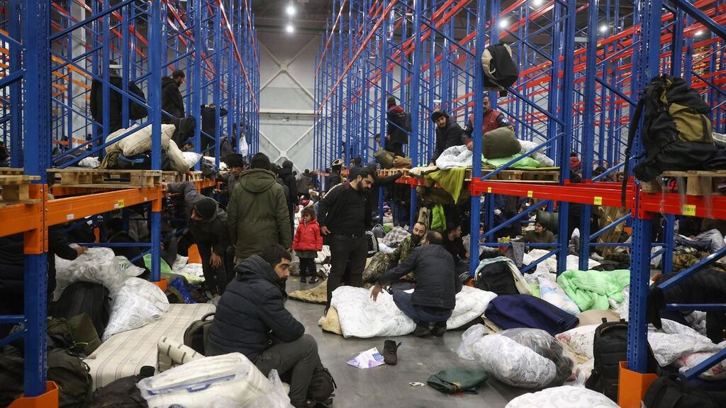 Hundreds of migrants were moved from the border to a warehouse in Belarus on Thursday night. Photograph: Leonid Shcheglov/Belta/AFP via Getty