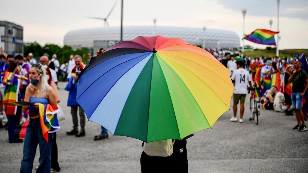 People wave rainbow flags in front of the Allianz Arena stadium in Munich in show of support for Pride. Photograph: Philipp Guelland