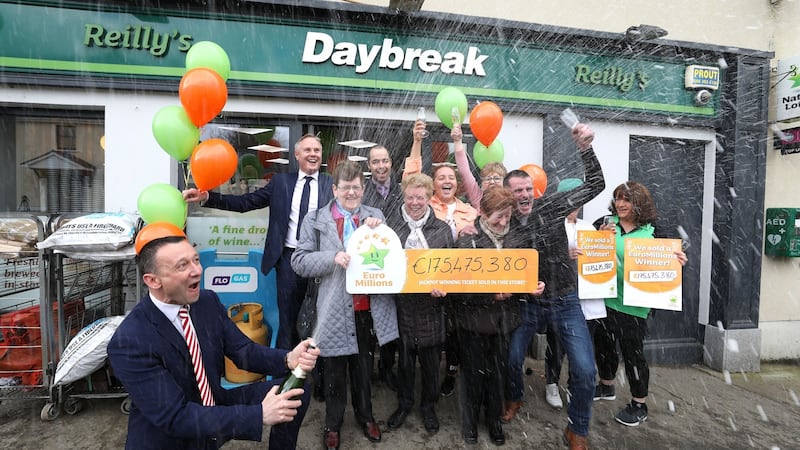 Les Reilly, owner of Reilly’s Daybreak Store in Naul, north Co Dublin, where the winning EuroMillions ticket was sold, celebrating with staff, customers and David Woods (left) of the National Lottery. Photograph: Mac Innes Photography