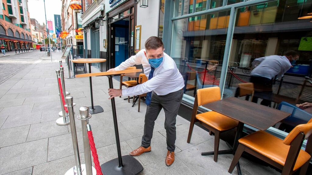An employee sets out tables for customers outside of a pub in Dublin on Friday. Photograph: Paul Faith/AFP