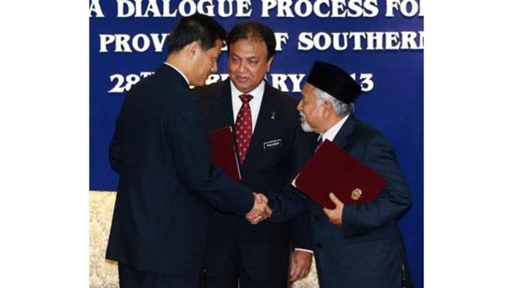 Secretary-general of Thailand's National Security Council, Paradorn Pattanathabutr (left), shakes hands with chief of Thailand's National Revolution Front (BRN) liaison office in Malaysia, Hassan Taib (right). Photograph: Bazuki Muhammad/Reuters