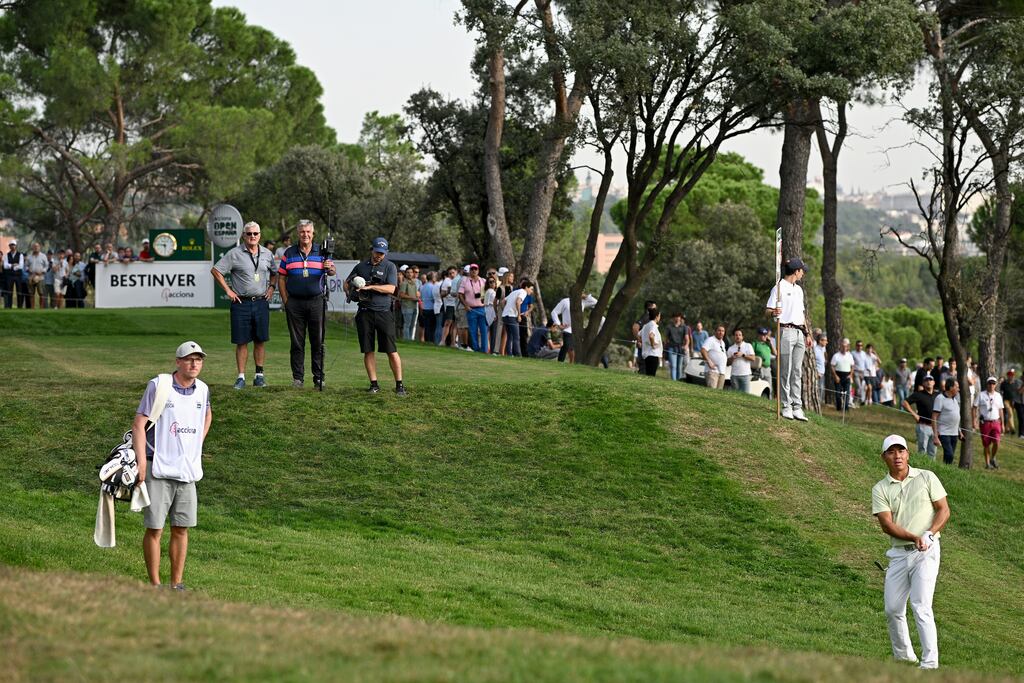 Ashun Wu of China plays his second shot on the 16th hole during Day Two of the acciona Open de Espana. Photograph: Stuart Franklin/Getty