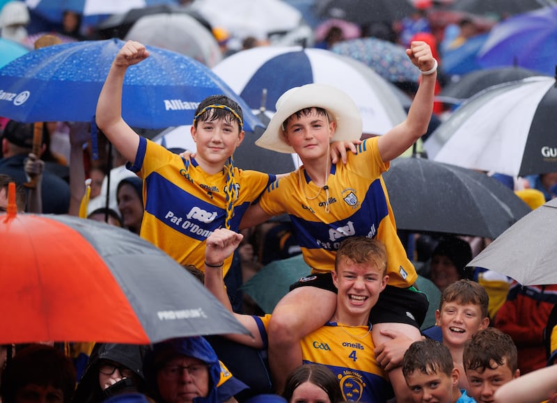 Clare fans brave the conditions during the homecoming at Wolfe Tones GAA in Shannon on Monday evening. Photograph: Tom Maher/Inpho