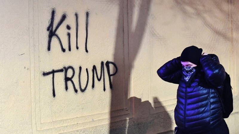 A woman passes graffiti written by protesters who held a demonstration against the Breitbart News editor’s speech. Photograph: Noah Berger/EPA
