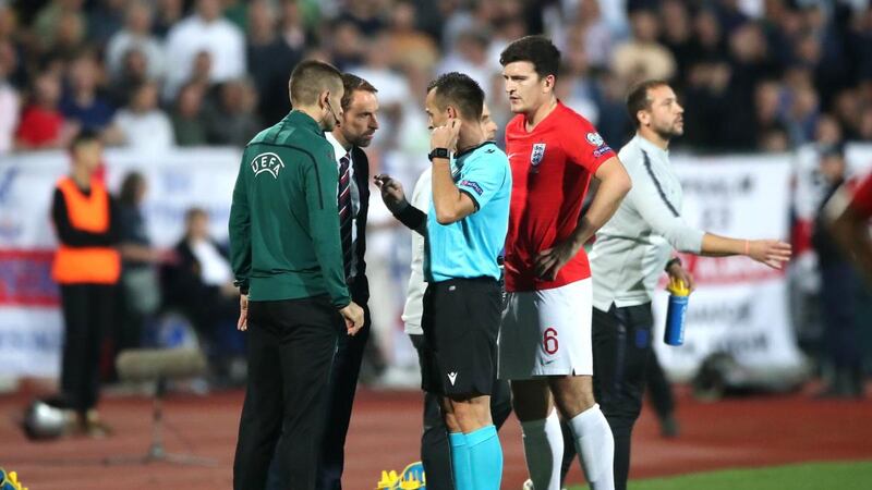 Match referee Ivan Bebek speaks to England manager Gareth Southgate with regards to racist chanting from fans. Photo: Nick Potts/PA Wire.