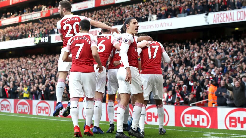 Arsenal players celebrate Pierre-Emerick Aubameyang’s goal against Tottenham at Emirates Stadium on Sunday,  as a banana skin is thrown onto the pitch.  Photograph: Nick Potts/PA Wire