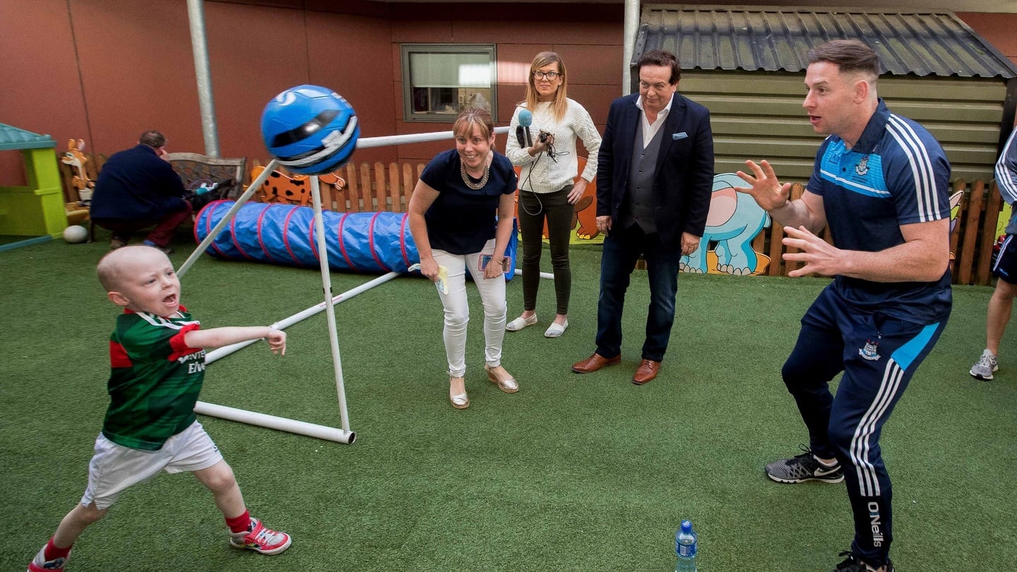 Cathal Downey plays football with Dublin’s Philly McMahon at Our Lady’s Children’s Hospital, Crumlin. Photograph: ©INPHO/Morgan Treacy