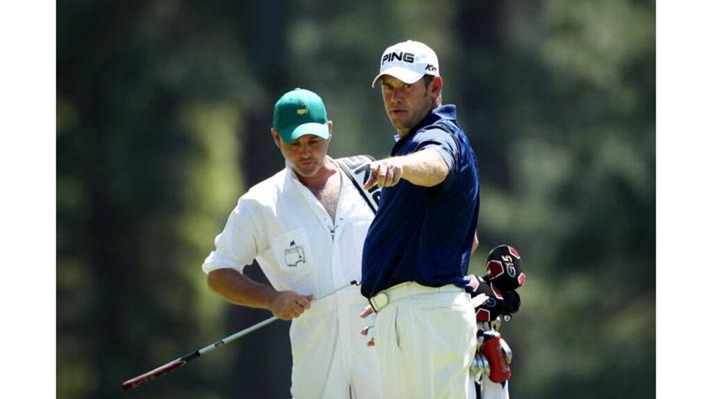 Lee Westwood chats with his caddie Billy Foster during a practice round prior to this week's US Masters at Augusta, Georgia. Photograph: Andrew Redington/Getty Images