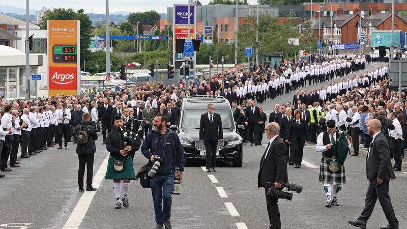 The funeral procession of former leading IRA figure Bobby Storey in west Belfast. Who were the men dressed in a uniform of black slacks, white shirts and black ties? Photograph: Liam McBurney/PA Wire