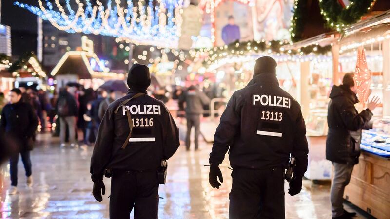 Police patrol at the reopened Christmas market in Berlin after a deadly truck attack. Photograph: Clemens Bilan/AFP/Getty Images