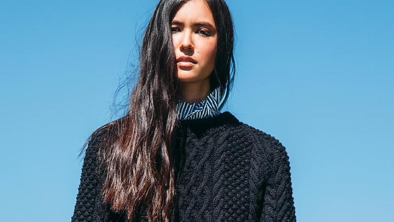 Black cable knit jumper €675 by Faye Dinsmore, navy and white cotton striped shirt €850 by Balenciaga.