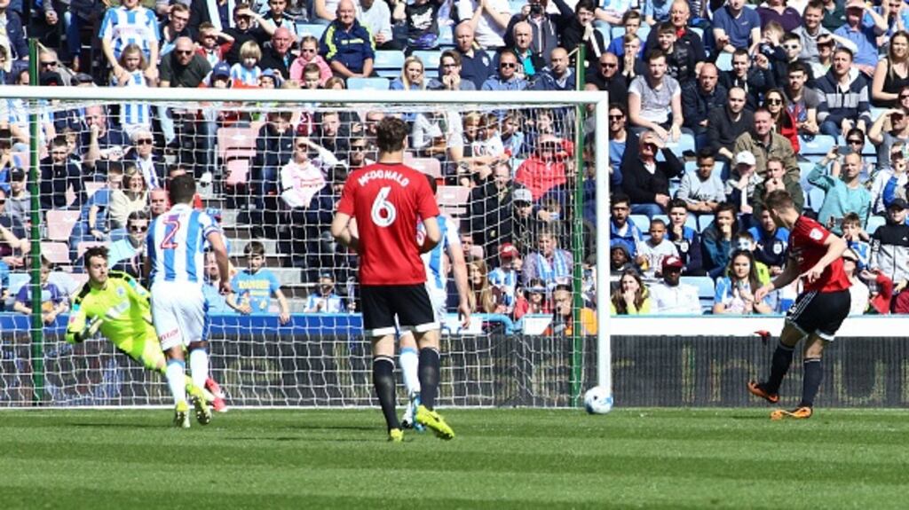 Fulham’s Tom Cairney scores from the penalty spot at John Smith’s Stadium. Photograph: Reuters