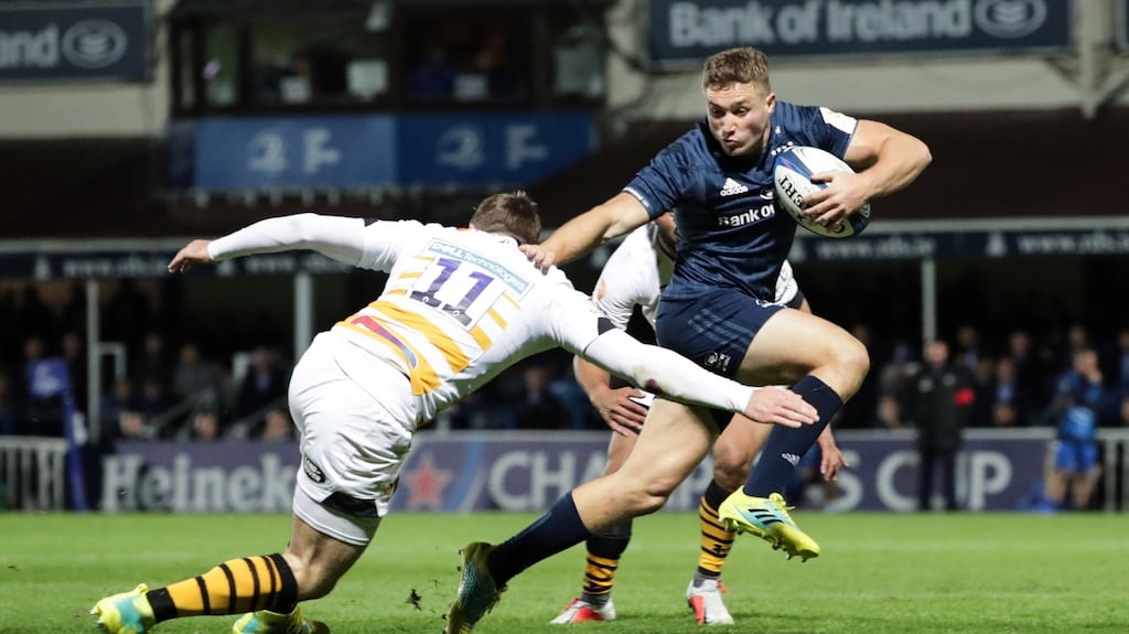 Leinster’s Jordan Larmour scores their sixth try despite an attempted tackle from Elliot Daly of Wasps during the Heineken Champions Cup match at the RDS. Photograph: Billy Stickland/Inpho