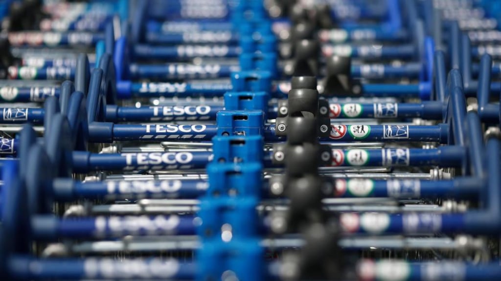 Tesco logos sit on the handles of shopping carts, stored outside a Tesco Extra Supermarket. Tesco had its worst sales decline in two decades, Kantar Worldpanel data showed today. Photo: Bloomberg