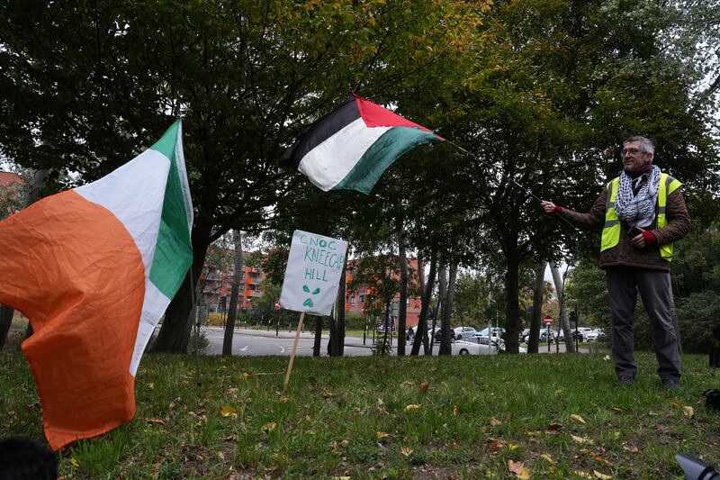 A supporters on "Cnoc Kneecap Hill" outside court on Friday. Photograph: Carlos Jasso/Getty