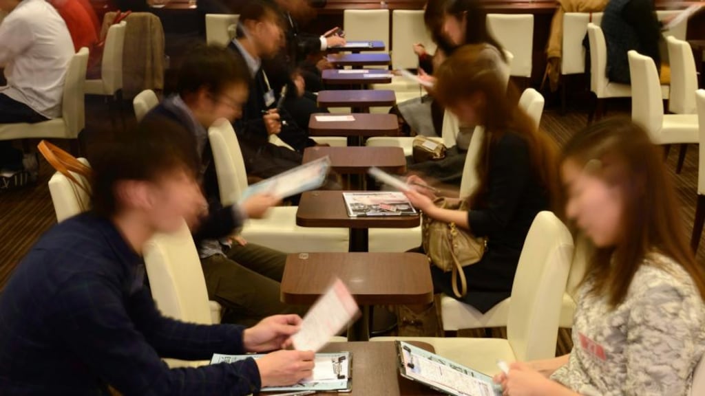 Attendees take notes while talking to each other at a matchmaking party hosted in Tokyo. Japan’s fertility rate is among the lowest in the world and its demographic dilemma grows more urgent year by year. Photograph: Akio Kon/Bloomberg