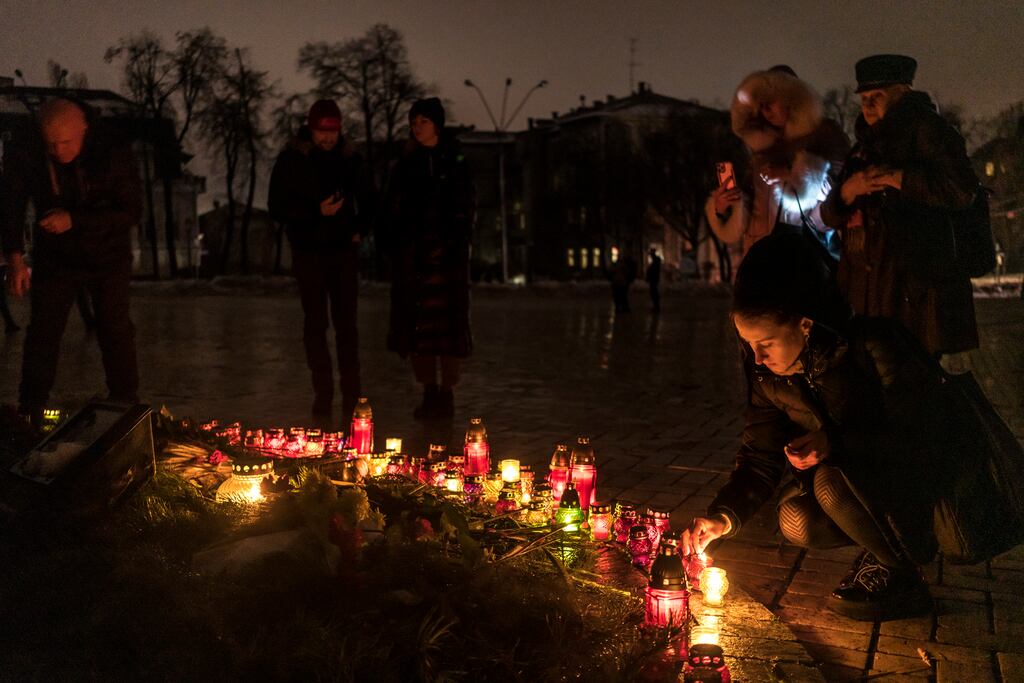 People at Mikhailivskyi Square in Kyiv place candles to commemorate the Holodomor, the Stalin-era famine that killed millions of Ukrainians when grain was confiscated during collectivisation. Photograph: Brendan Hoffman/The New York Times