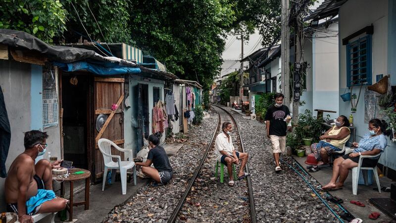People who live along railroad tracks in part of the Klong Toey slum, Bangkok. Photograph: Adam Dean/The New York Times