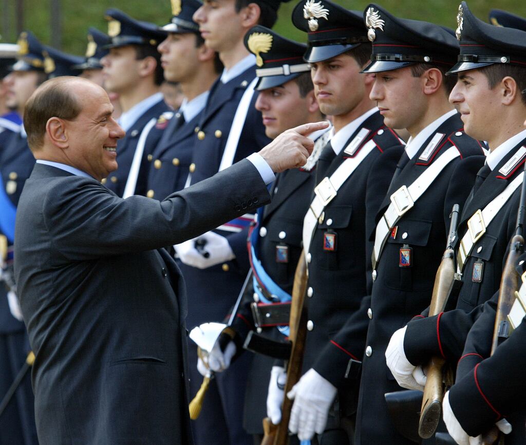 Then Italian prime minister Silvio Berlusconi jokes with Italian paramilitary police in Rome, November 2002. Photograph: Gabriel Bouys/AFP via Getty