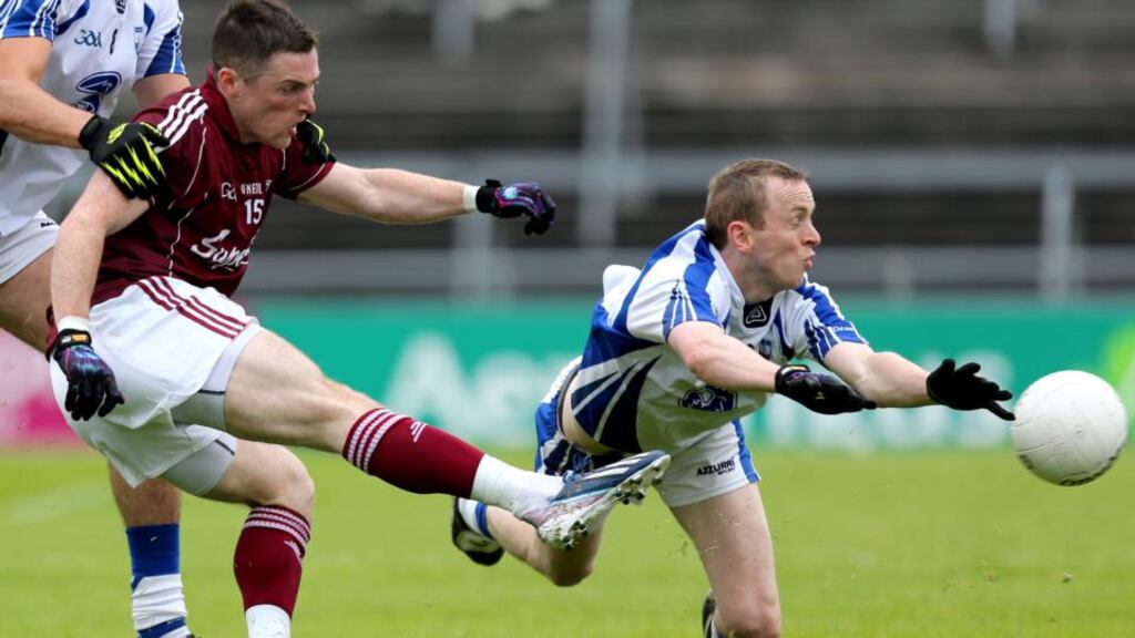 Waterford’s Shane Aherne dives in to block down Danny Cummins of Galway. Photograph: James Crombie/Inpho