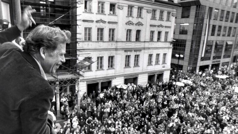 Presidential candidate Vaclav Havel waves to his supporters from a balcony in Prague in 1989. Photograph: Petar Kujundzic/Reuters